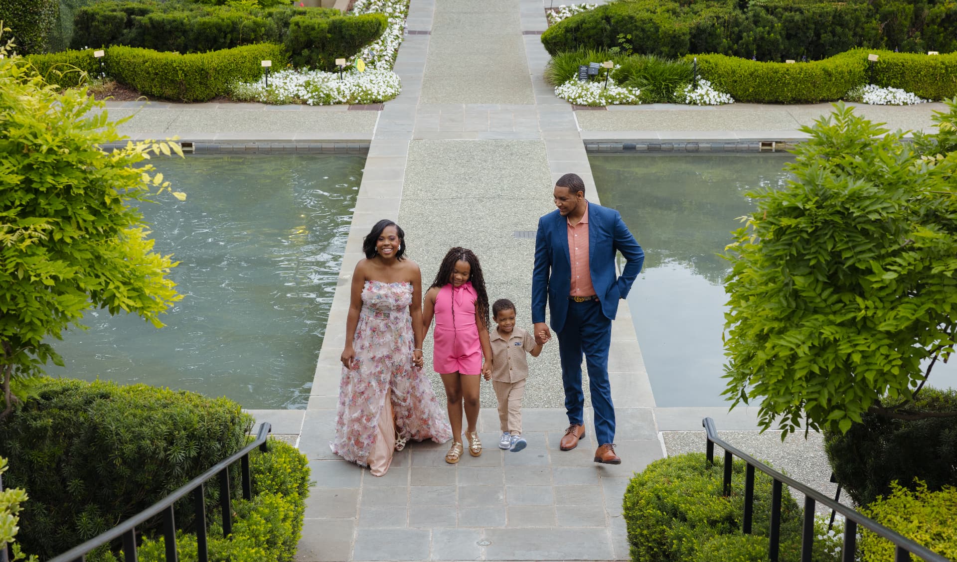 Jordan with his wife Taran and kids Rhian and Jordan walking together by the water gardens